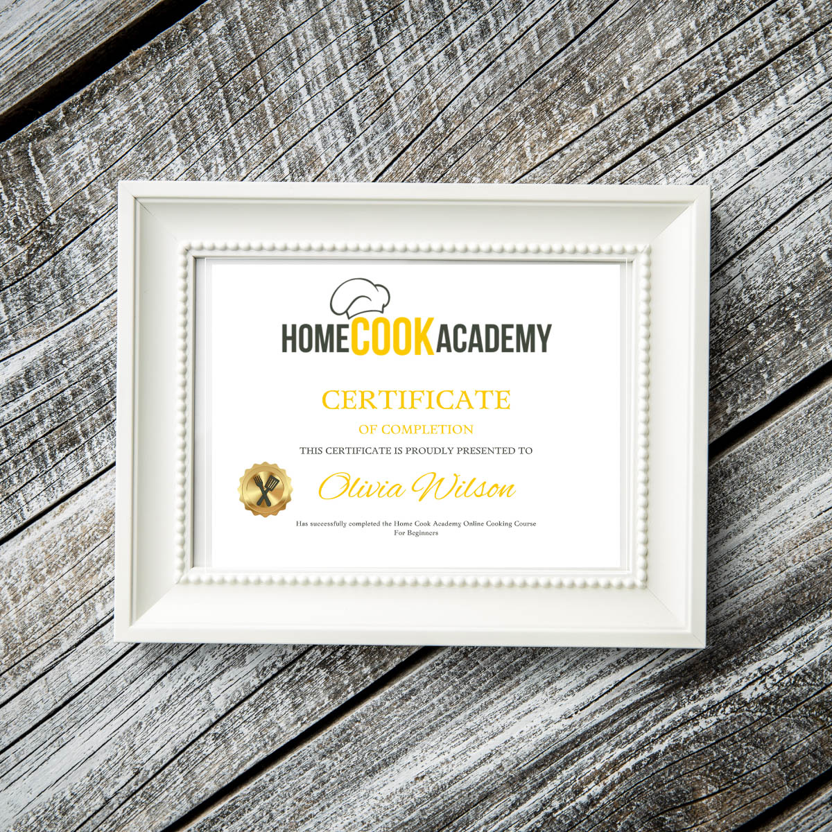 Online cooking course certificate in a frame on a wooden background
