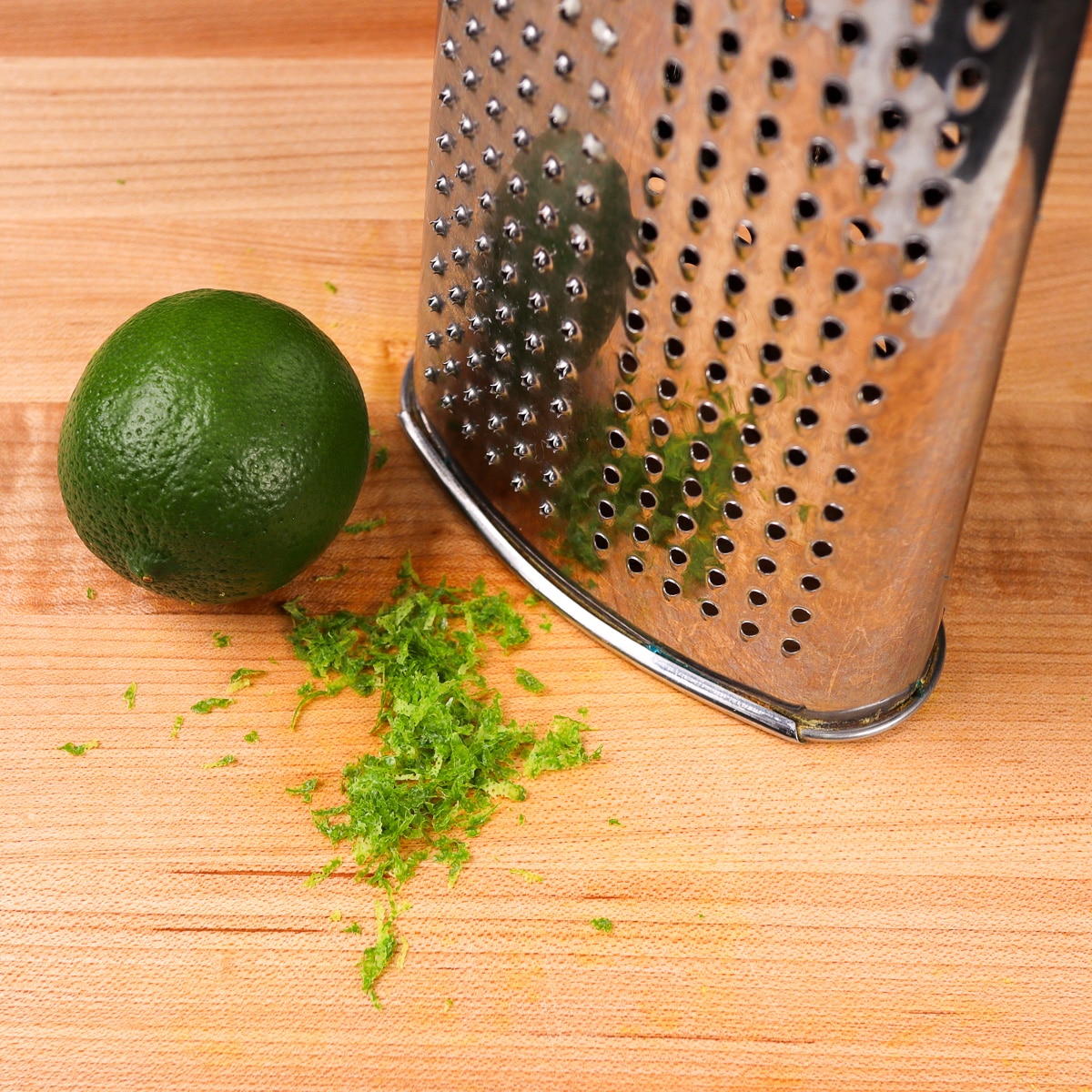 lime zest in front of a box grater
