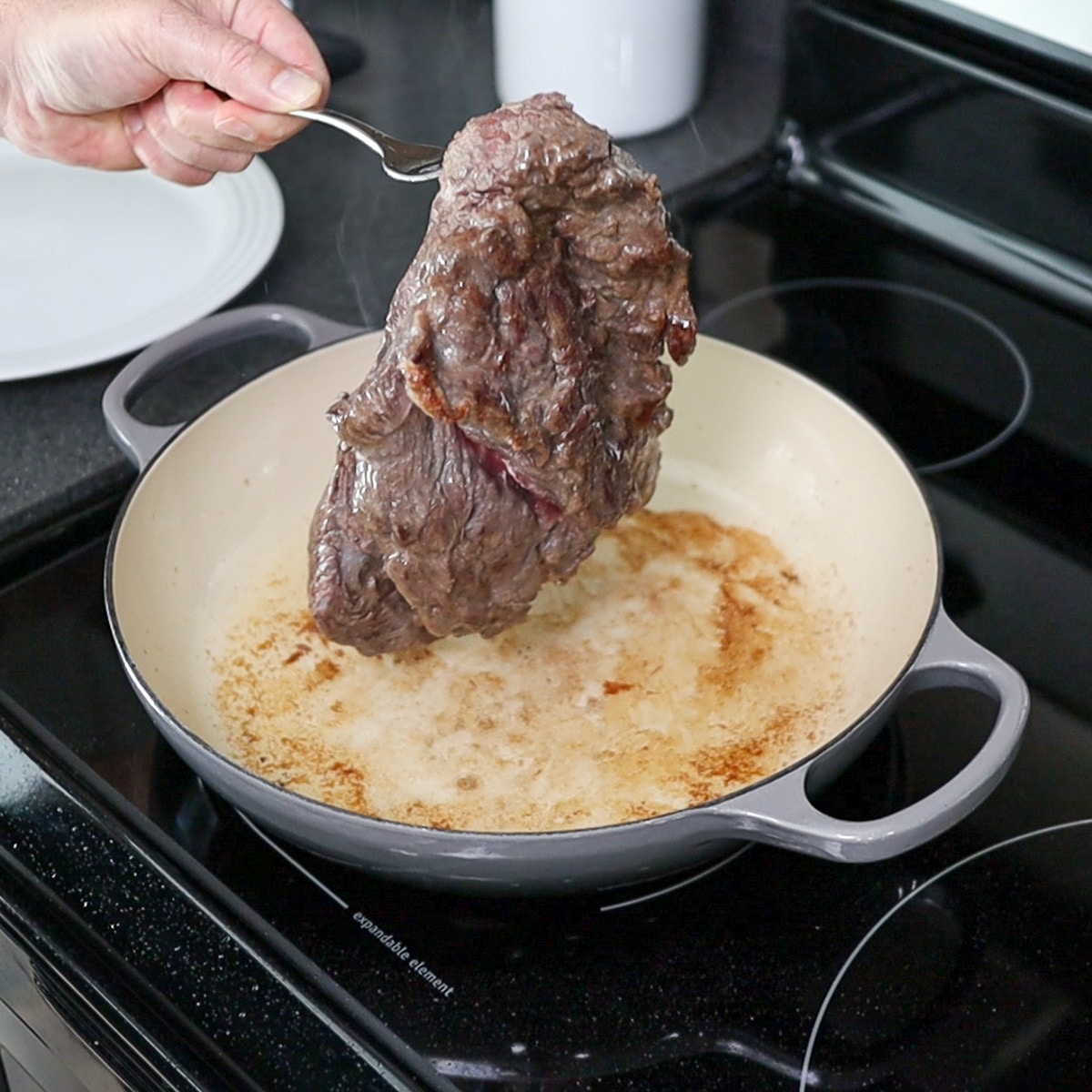 browning the beef in  a pan