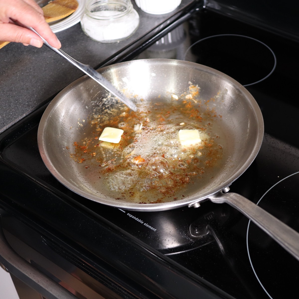 adding butter to the hot skillet