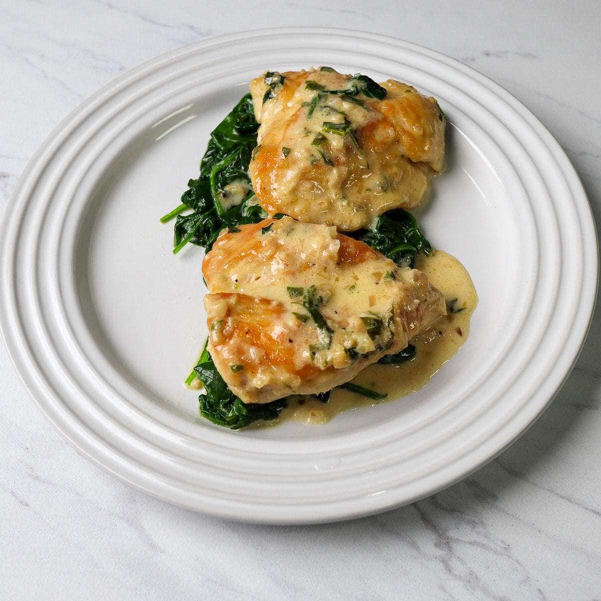 chicken florentine plated on a white plate